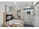 Bathroom with tub, shower, fireplace and window at 134 Wentworth Dr, Henderson, NV 89074