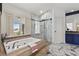 Bathroom featuring marble floors, a bathtub and walk-in shower at 134 Wentworth Dr, Henderson, NV 89074
