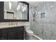 Elegant bathroom with marble tile, glass-enclosed shower, and modern fixtures at 134 Wentworth Dr, Henderson, NV 89074