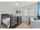 Cozy bedroom with a ceiling fan, natural light, and a stylish desk area at 134 Wentworth Dr, Henderson, NV 89074