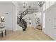 Bright foyer with tile flooring, staircase with iron railings, and decorative chandelier at 134 Wentworth Dr, Henderson, NV 89074