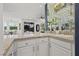 Wet bar with granite countertop, mirrored backsplash, and open view to living area at 134 Wentworth Dr, Henderson, NV 89074