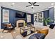 Cozy living room with a fireplace, comfortable seating, and custom built-in shelving at 134 Wentworth Dr, Henderson, NV 89074