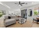 Comfortable living room featuring a sectional sofa, ceiling fan, and sliding glass doors at 134 Wentworth Dr, Henderson, NV 89074