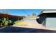 Spacious backyard featuring a brick patio area, gravel area, and a modern wooden fence at 1801 Griffith Ave, Las Vegas, NV 89104