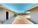 Spacious backyard featuring a brick-paved patio, desert landscaping, and an open garage at 1801 Griffith Ave, Las Vegas, NV 89104
