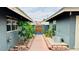 Shady backyard pathway with plants and desert landscaping at 1801 Griffith Ave, Las Vegas, NV 89104