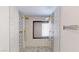 This updated bathroom has a dual shower head, black trim, and decorative hexagon tile at 1801 Griffith Ave, Las Vegas, NV 89104
