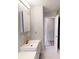 Modern bathroom with white cabinets, gold fixtures, and a doorway leading to another room at 1801 Griffith Ave, Las Vegas, NV 89104