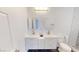 Well-lit bathroom featuring dual vanities, a toilet, and black and white hexagon tile floor at 1801 Griffith Ave, Las Vegas, NV 89104