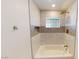 Updated bathroom featuring a bathtub and gold fixtures with modern hexagon tile accents at 1801 Griffith Ave, Las Vegas, NV 89104