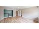 Bright bedroom featuring wood-look floors, a walk-in closet with shelving, and neutral paint throughout at 1801 Griffith Ave, Las Vegas, NV 89104