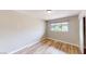 Bright bedroom featuring wood-look floors and a window overlooking the neighborhood at 1801 Griffith Ave, Las Vegas, NV 89104