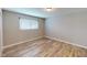 This bedroom boasts a spacious layout with wood-look floors and ample natural light at 1801 Griffith Ave, Las Vegas, NV 89104