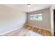 Bedroom with wood-look floors, a window, and a serene, neutral color scheme at 1801 Griffith Ave, Las Vegas, NV 89104