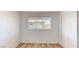This bedroom has wood-look floors, a window for natural light, and a closet with paneled doors at 1801 Griffith Ave, Las Vegas, NV 89104