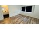 Spacious bedroom with vinyl floors, large window, and ensuite bathroom at 1801 Griffith Ave, Las Vegas, NV 89104