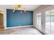 Dining room with statement blue geometric wallpaper, stylish light fixture and access to outdoor patio at 1801 Griffith Ave, Las Vegas, NV 89104