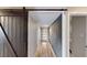 Modern hallway featuring a sliding barn door, contemporary wall accents, and stylish flooring, leading to other living spaces at 1801 Griffith Ave, Las Vegas, NV 89104