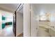 Hallway that leads into a bathroom, kitchen, and rooms with sliding doors at 1801 Griffith Ave, Las Vegas, NV 89104
