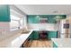 Updated kitchen with green cabinets, stainless steel appliances, modern countertops and ample natural light at 1801 Griffith Ave, Las Vegas, NV 89104