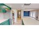 Open kitchen and dining area with stainless steel appliances and green cabinets at 1801 Griffith Ave, Las Vegas, NV 89104