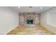 Bright living room with a wood-burning fireplace, modern floors, and ample natural light at 1801 Griffith Ave, Las Vegas, NV 89104