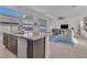 Bright, open-concept kitchen featuring a granite island, stainless steel appliances, and seamless flow to the living area at 2494 Veronella St, Henderson, NV 89044