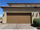 Attached two-car garage with brown door offering convenient parking and storage, plus desert landscaping at 2664 Frabiele St, Henderson, NV 89044