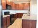 Kitchen featuring granite counters, stainless steel appliances, and dark wood cabinets at 2664 Frabiele St, Henderson, NV 89044