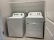 Bright laundry room with Whirlpool washer and dryer on ceramic tile flooring, ready for convenient chores at 2664 Frabiele St, Henderson, NV 89044