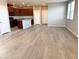 Spacious living room with wood-look flooring and natural light, leading into an open-concept kitchen at 2664 Frabiele St, Henderson, NV 89044