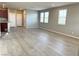 Open-concept living room with wood-look flooring, connecting seamlessly to the kitchen area at 2664 Frabiele St, Henderson, NV 89044