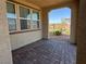 Covered patio with brick pavers, offering a cozy outdoor space with view of the landscaped neighborhood at 2664 Frabiele St, Henderson, NV 89044