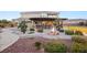 Expansive backyard featuring an outdoor kitchen, a cozy fire pit, and lush landscaping at 6004 Chessington Ave, Las Vegas, NV 89131