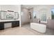 Elegant primary bathroom featuring freestanding tub, walk-in shower, and sleek fixtures at 6004 Chessington Ave, Las Vegas, NV 89131