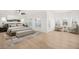 Spacious primary bedroom showcasing neutral tones, plantation shutters, and seating area at 6004 Chessington Ave, Las Vegas, NV 89131