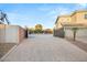 Wide brick driveway with a basketball hoop and an attached two-car garage at 6004 Chessington Ave, Las Vegas, NV 89131