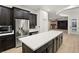 Modern kitchen with stainless steel appliances, a large island, and custom cabinets at 6004 Chessington Ave, Las Vegas, NV 89131