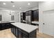 Spacious kitchen with a large island, stainless steel appliances, and custom cabinets at 6004 Chessington Ave, Las Vegas, NV 89131