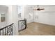 Upstairs loft area offering natural light and views, with black iron railing at 6004 Chessington Ave, Las Vegas, NV 89131