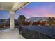 Relaxing patio with wrought iron railing offering views of the surrounding landscape and mountains at 6004 Chessington Ave, Las Vegas, NV 89131