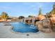 Beautiful pool with rock waterfall feature creating a luxurious backyard oasis at 6004 Chessington Ave, Las Vegas, NV 89131