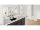 Modern bathroom vanity with black cabinets, white countertop, and open doorway at 6004 Chessington Ave, Las Vegas, NV 89131