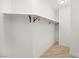 Bright walk-in closet features a wood rod and plank flooring at 6004 Chessington Ave, Las Vegas, NV 89131