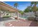 Fenced backyard offering a covered patio and serene views of the in-ground pool at 681 Peach Coral St, Las Vegas, NV 89183