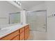 Bright bathroom with a double sink vanity, and glass enclosed shower-tub combo at 681 Peach Coral St, Las Vegas, NV 89183