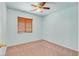 Neutral bedroom with ceiling fan and large window with blinds for natural light at 681 Peach Coral St, Las Vegas, NV 89183