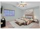 Relaxing bedroom offers a ceiling fan, plush bed, and natural light from the window at 681 Peach Coral St, Las Vegas, NV 89183