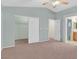 Bedroom featuring neutral carpet, walk in closet, and entry to the primary bathroom at 681 Peach Coral St, Las Vegas, NV 89183